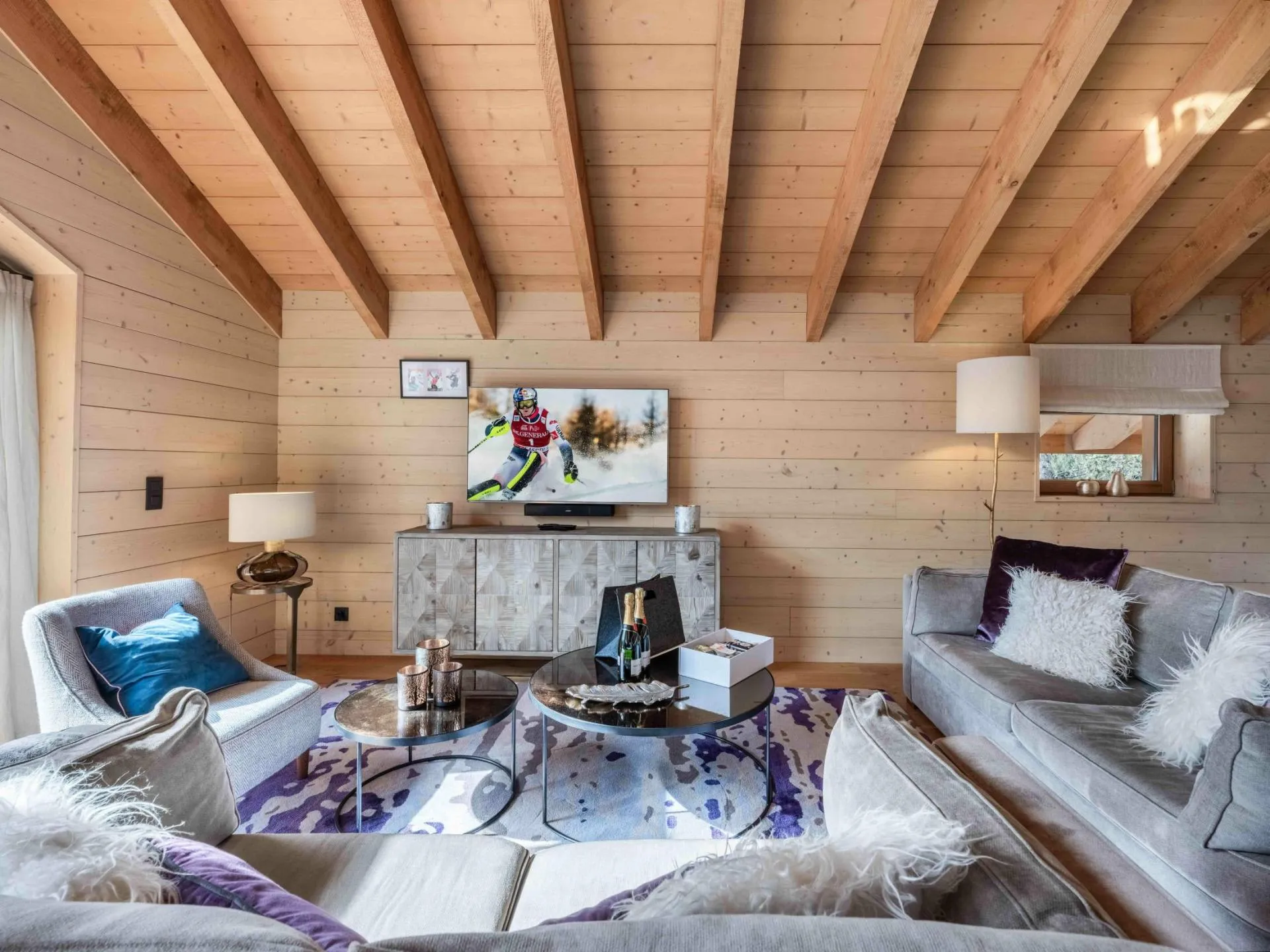 Living room with a vaulted timber ceiling and picture windows