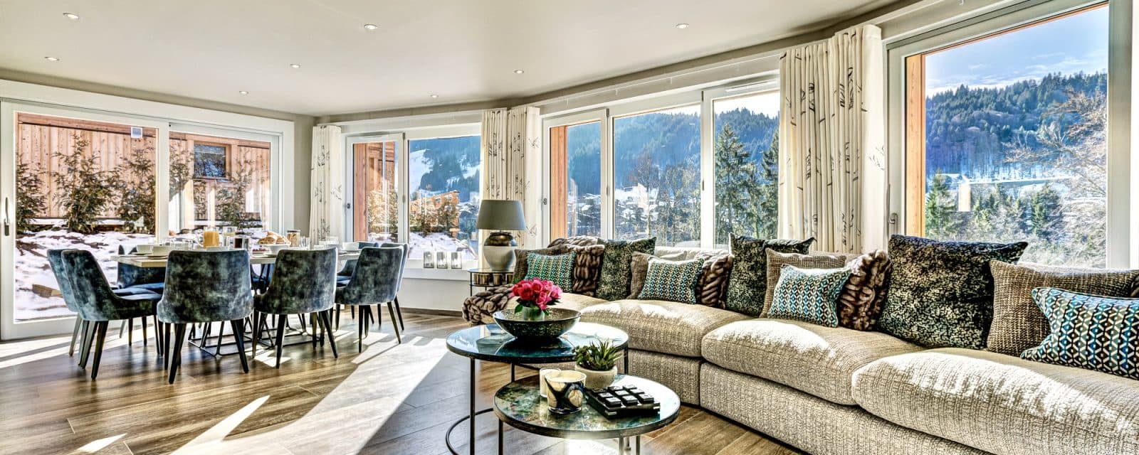 Open-plan living and dining with sectional seating for 8+; panoramic mountain views