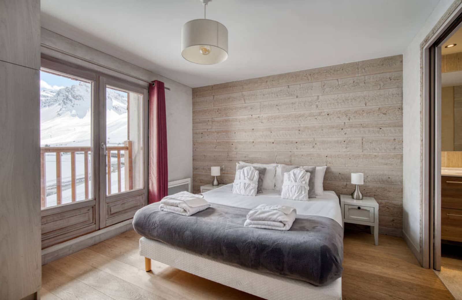 Primary bedroom with king bed and direct balcony access to mountain views