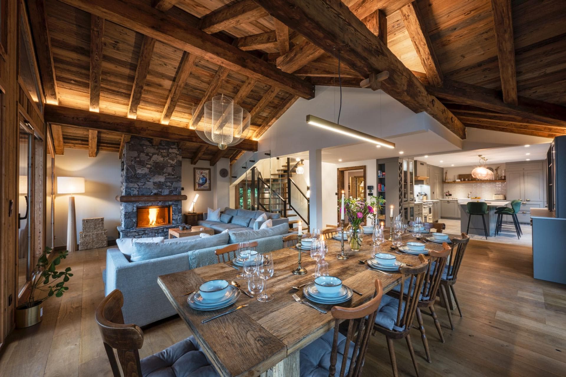 Open-plan living and dining area with timber ceiling and mountain views