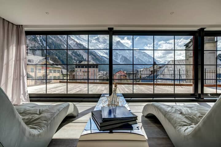 Lounge area with chaise seating and panoramic Alpine mountain views
