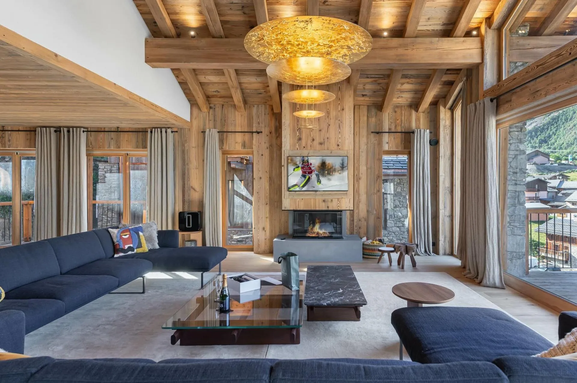 Living area with a wood fireplace and mountain views