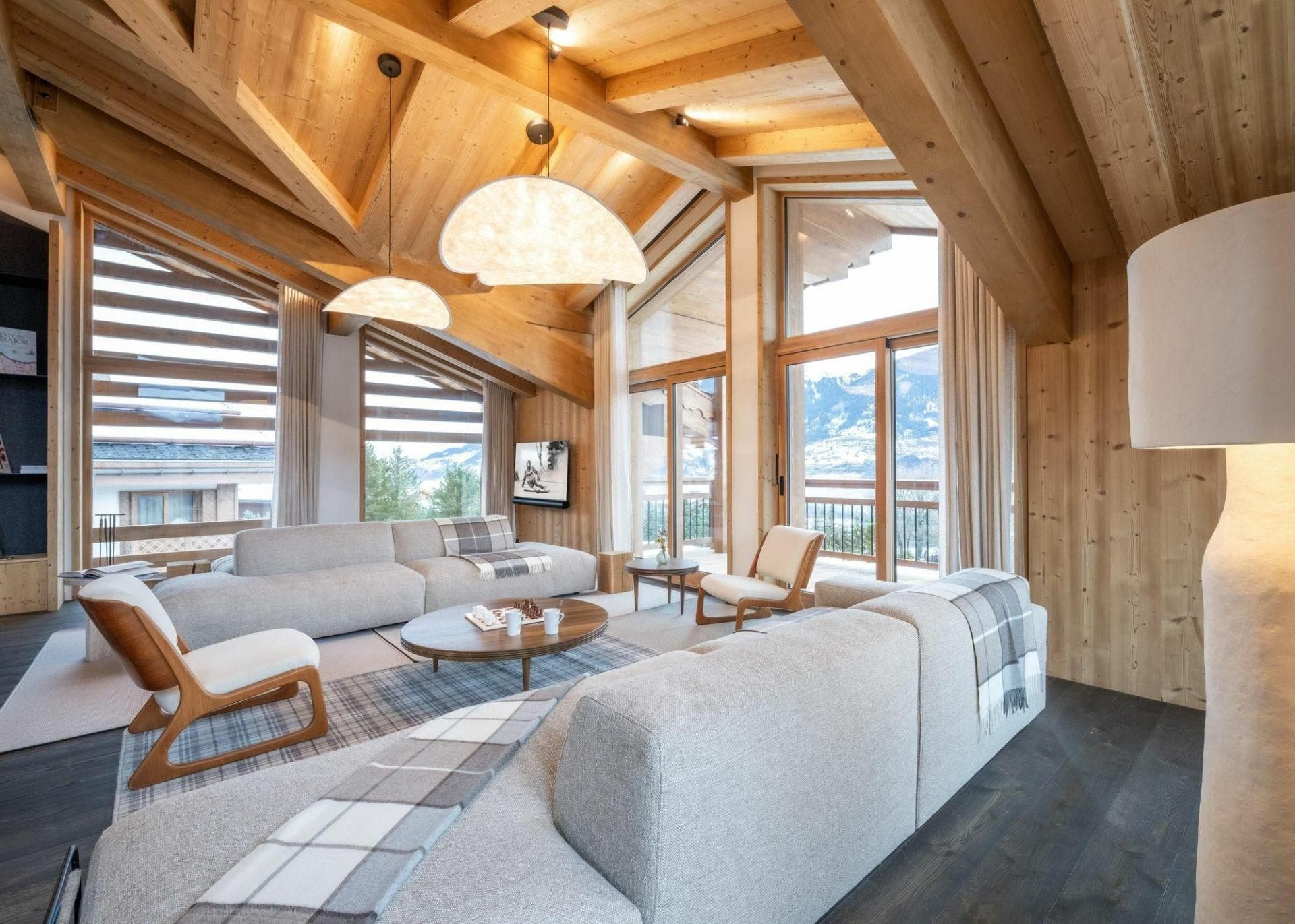 Open-plan living room with mountain views and balcony access