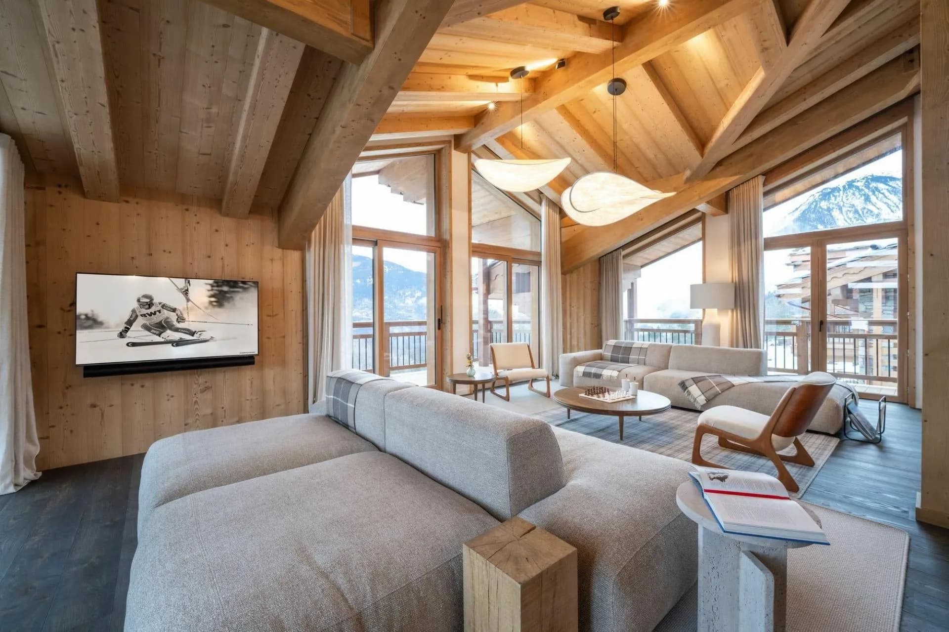 Living room seating area with a television and balcony doors