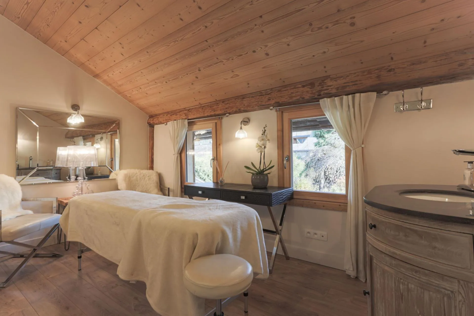 Private treatment room with massage table and vanity sink