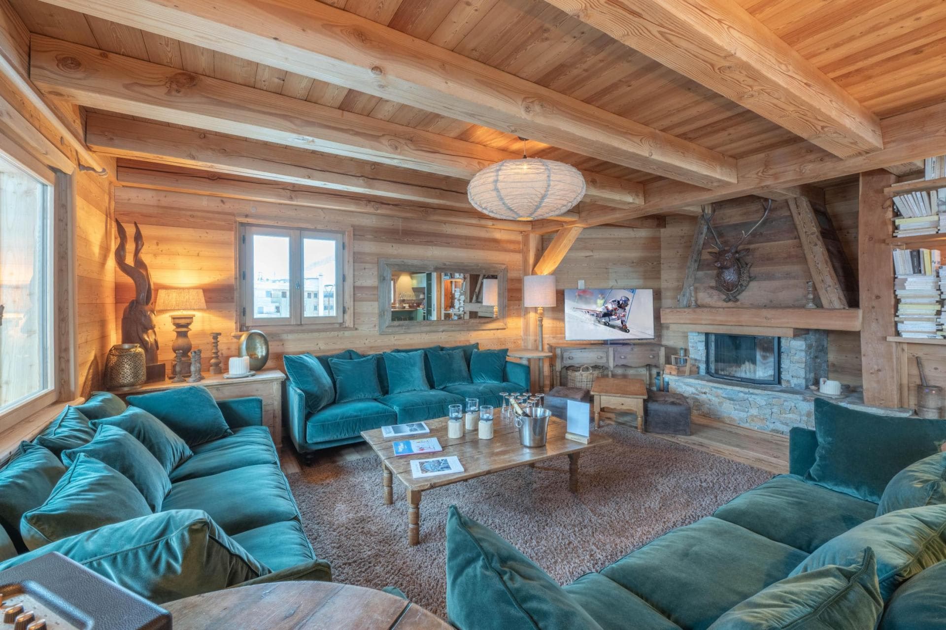 Living room with velvet seating and a stone fireplace