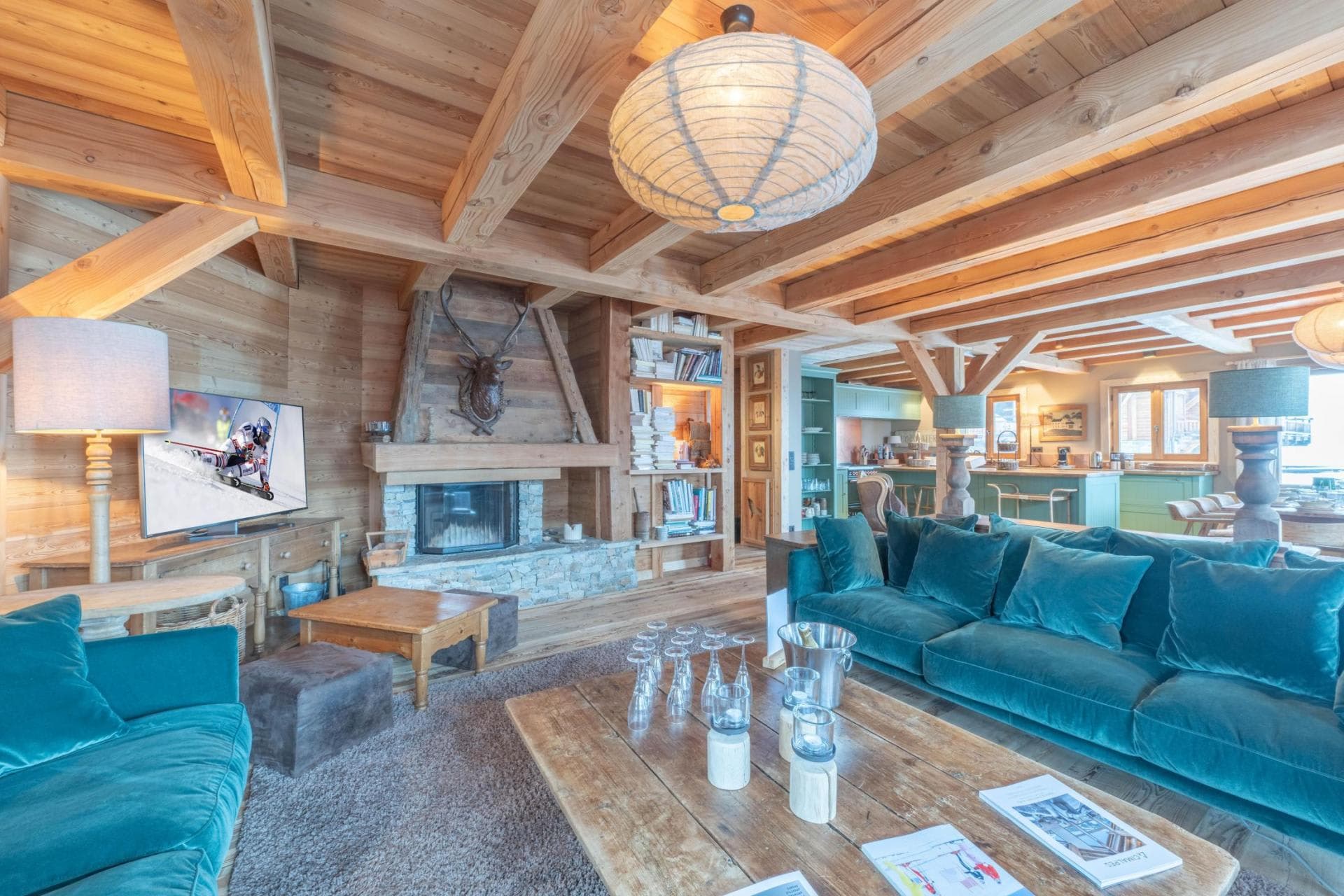 Living room with a timber-beamed ceiling and wood fireplace