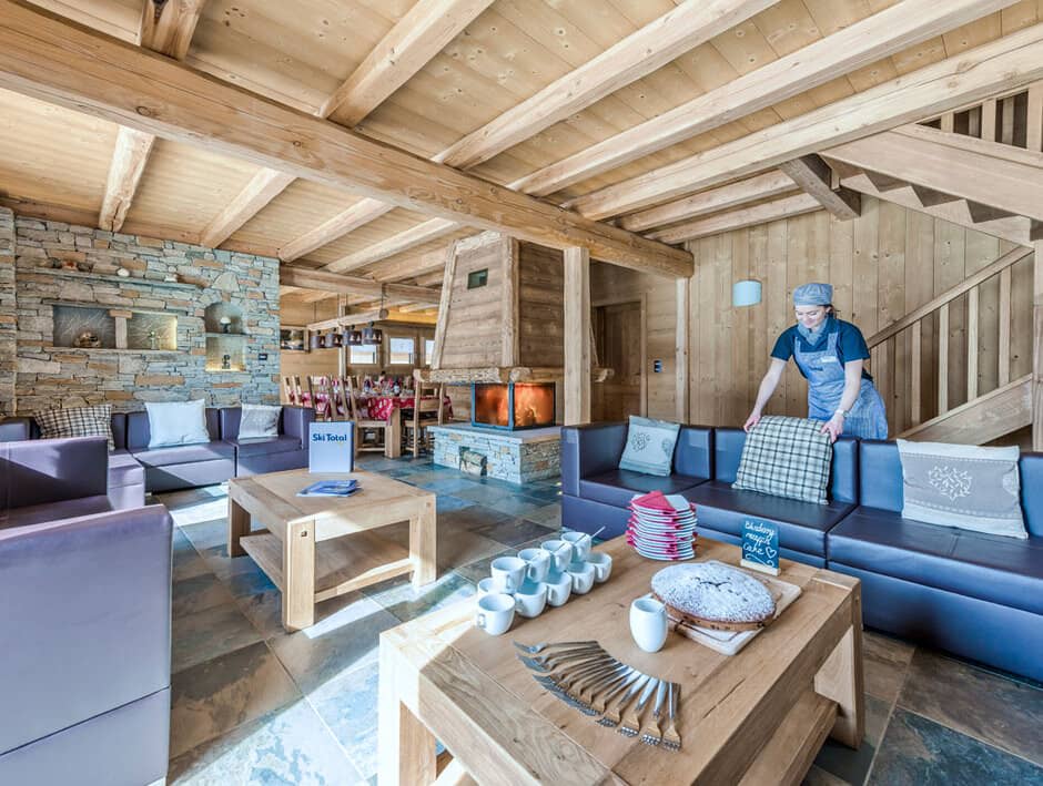 Open living area with central wood-burning fireplace and slate flooring