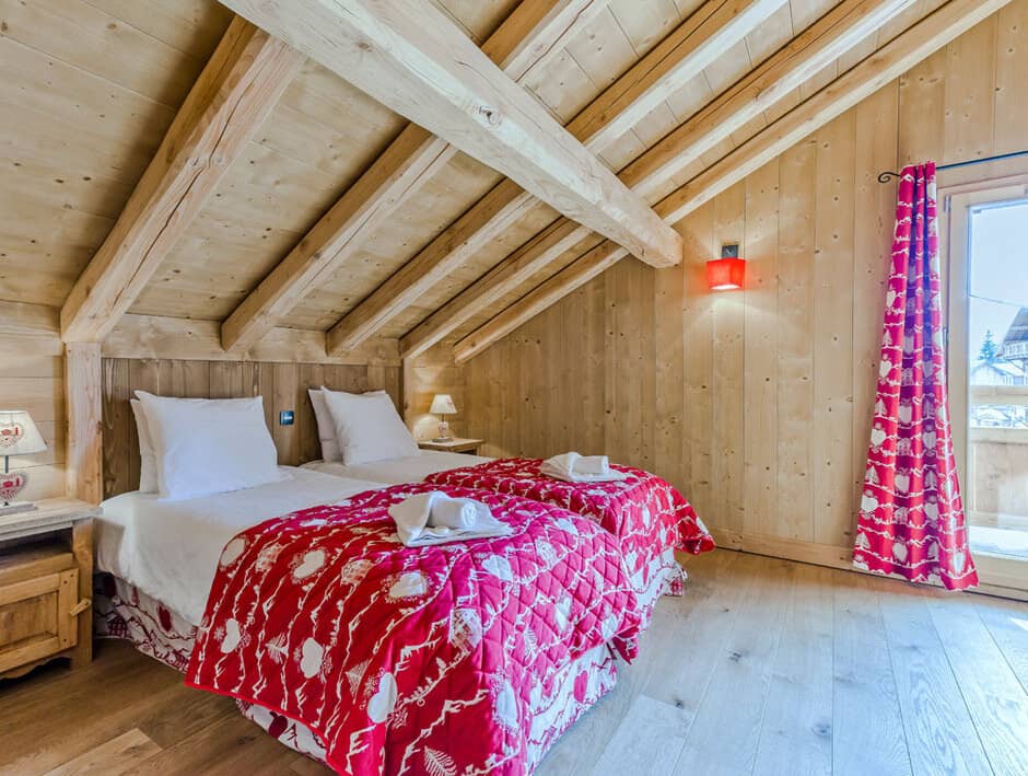 Attic bedroom with twin beds and private balcony access