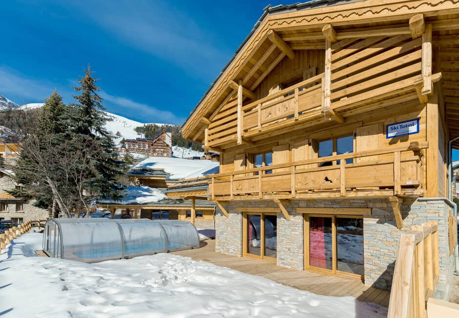 Chalet exterior featuring private deck and retractable pool enclosure