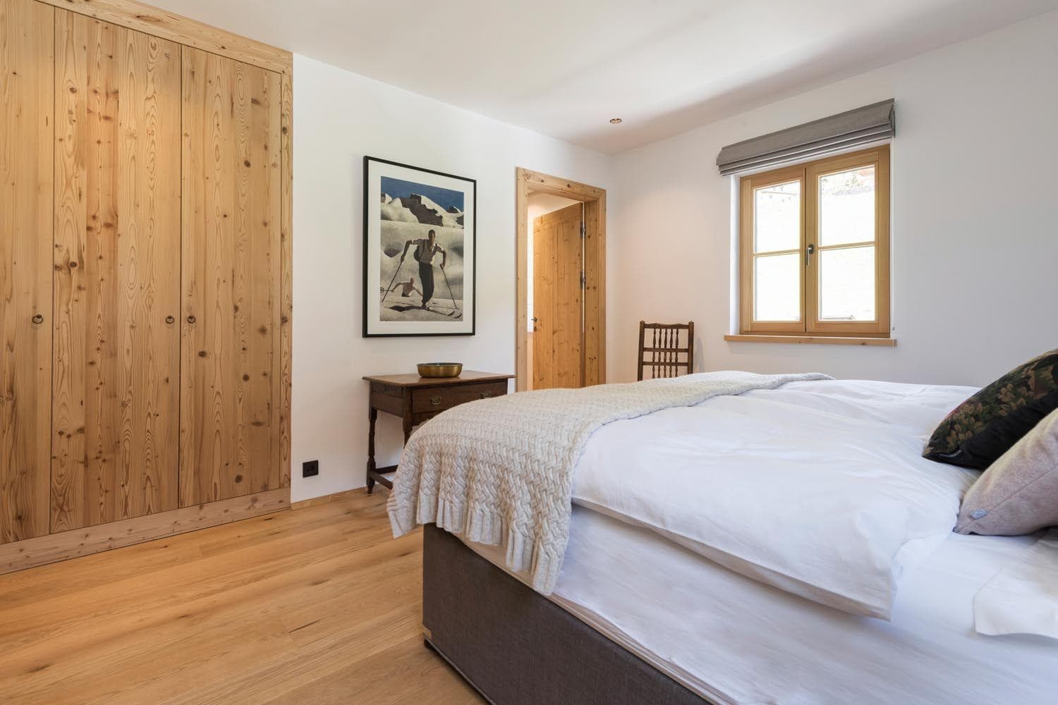Guest bedroom featuring floor-to-ceiling reclaimed wood wardrobes