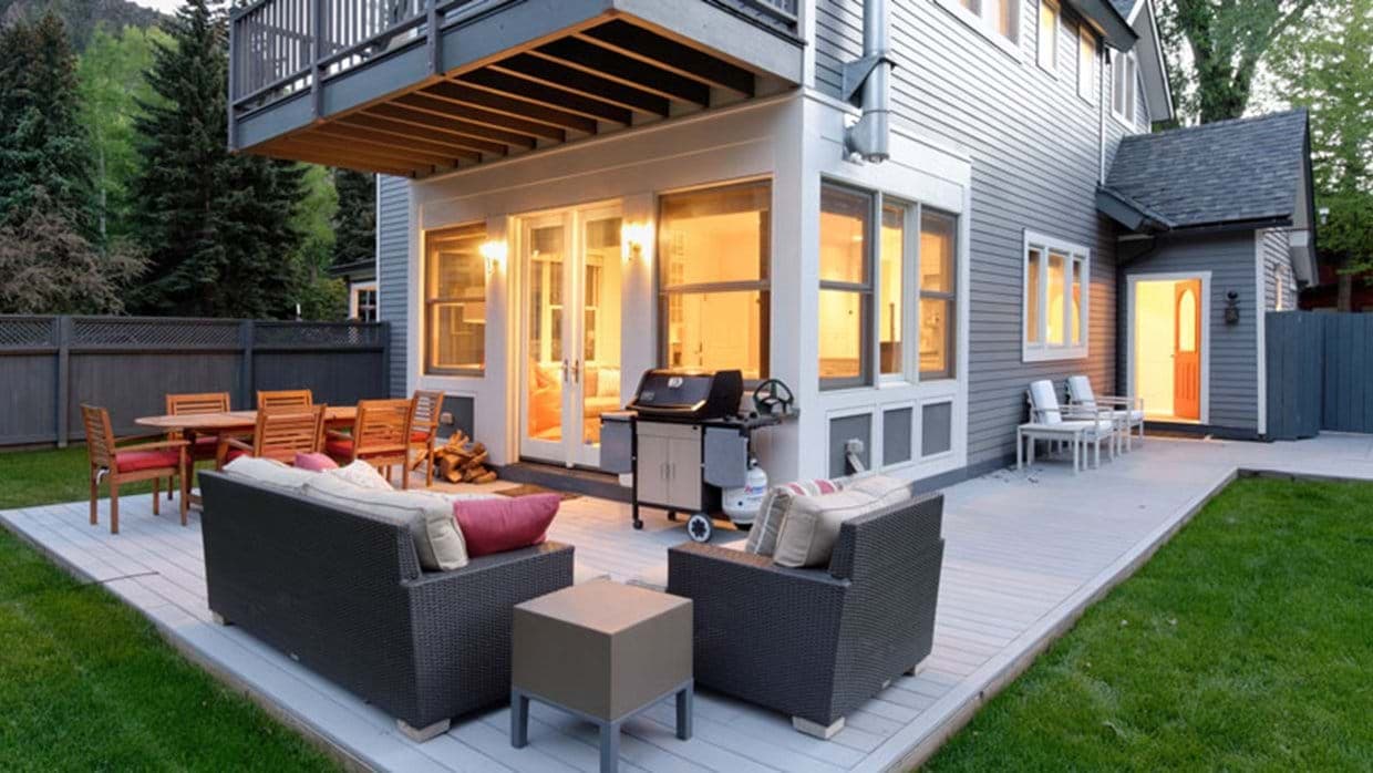 Rear deck with gas grill, dining table for 8, and lounge seating