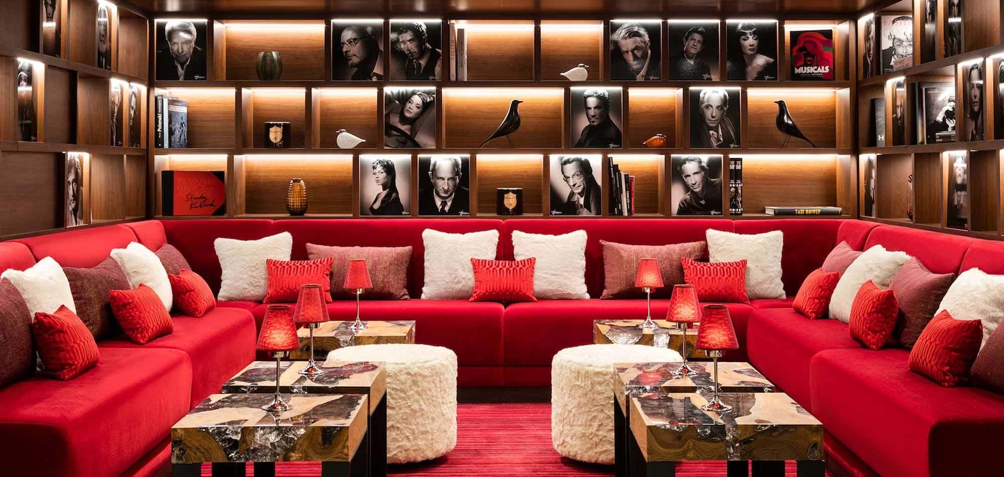 Media room with velvet u-shaped sectional and back-lit shelving