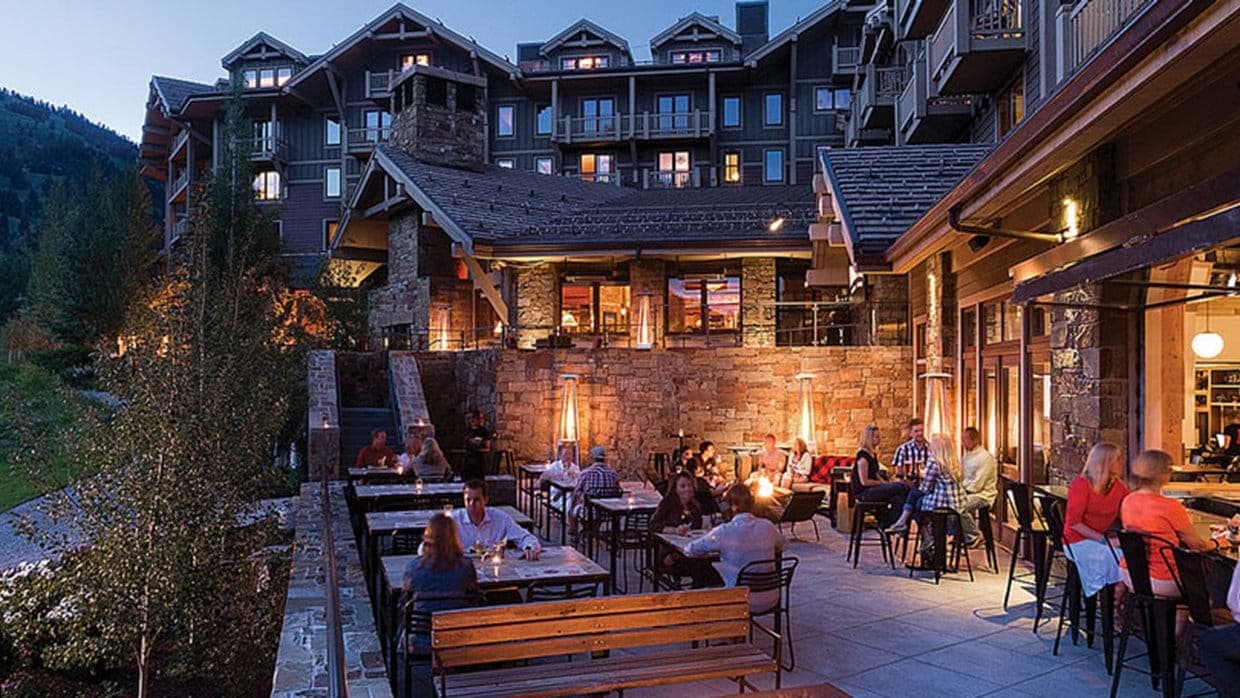 Shared outdoor patio with fire pits, heat lamps, and restaurant seating