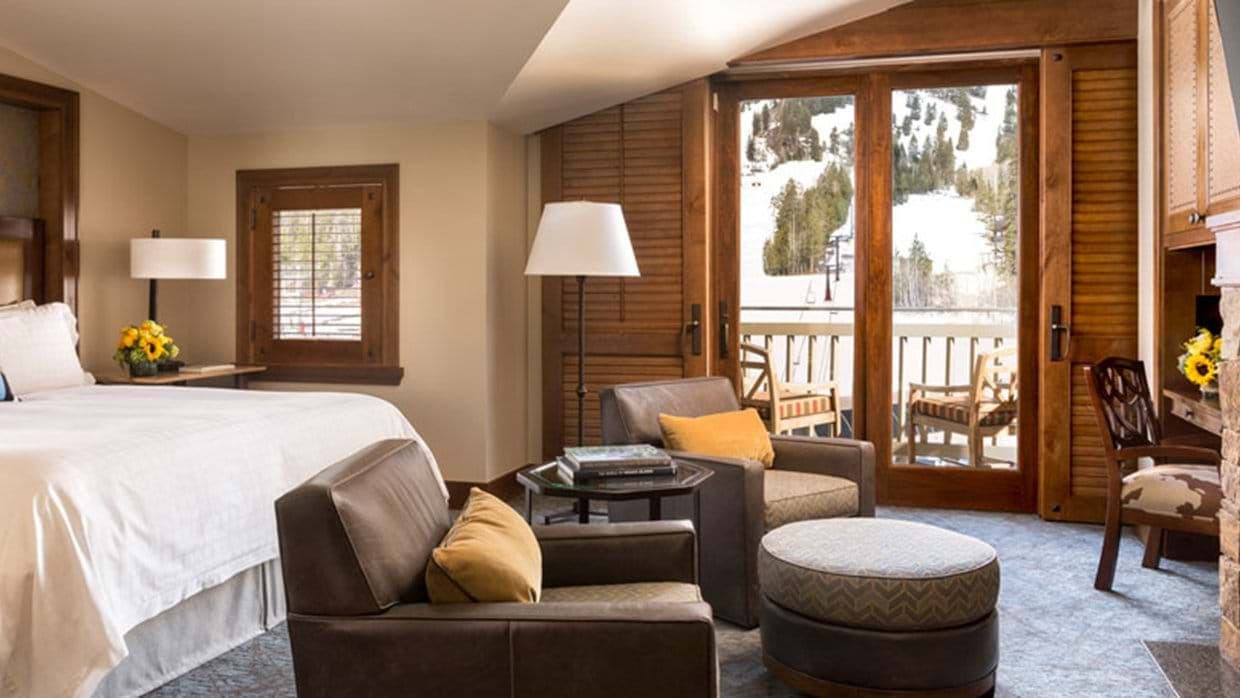 Primary bedroom with private balcony and ski-in/ski-out mountain views