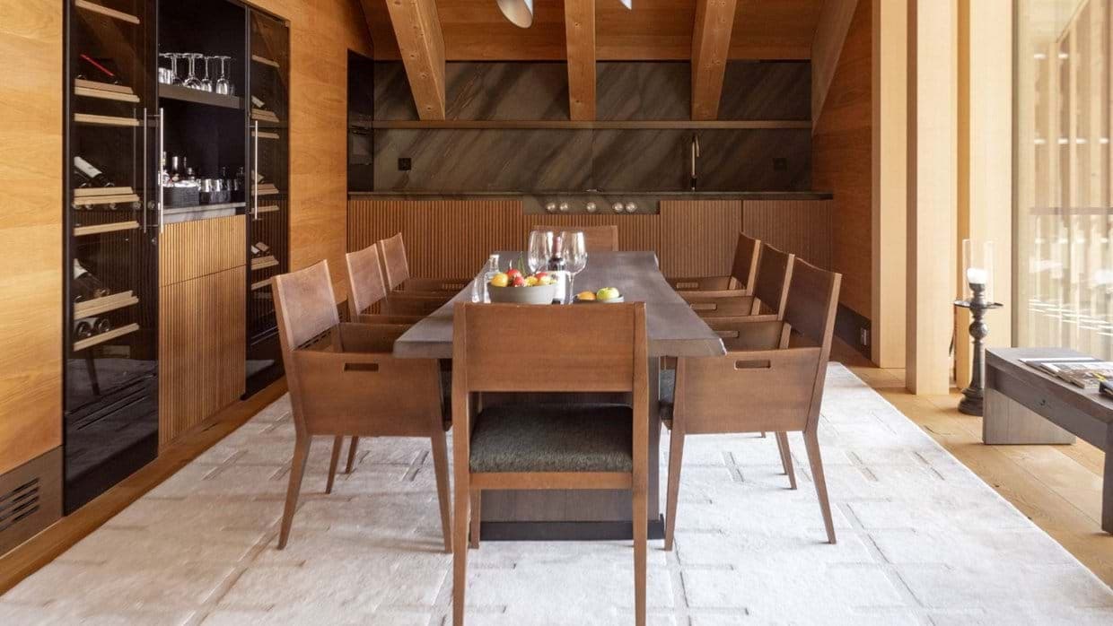 Dining area seats 8 with full-height wine fridge and wet bar