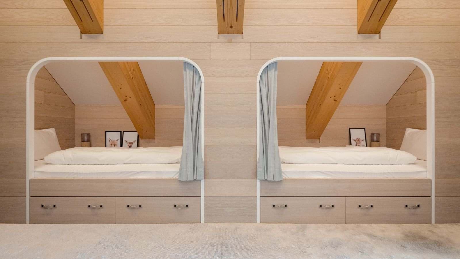 Built-in twin bunks with privacy curtains and under-bed storage drawers