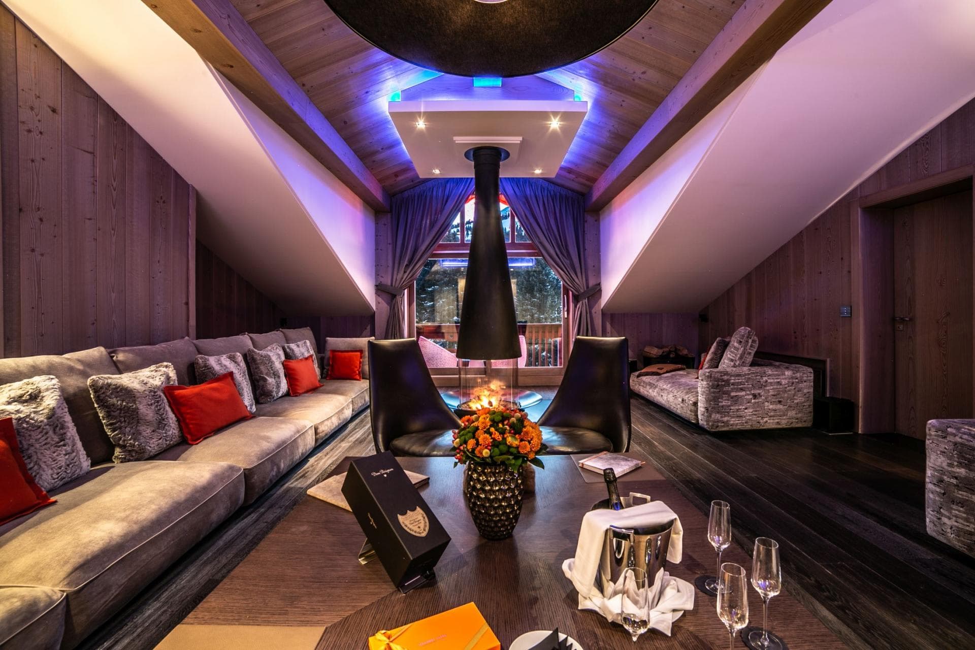 Top floor lounge with central wood-burning fireplace and vaulted ceilings