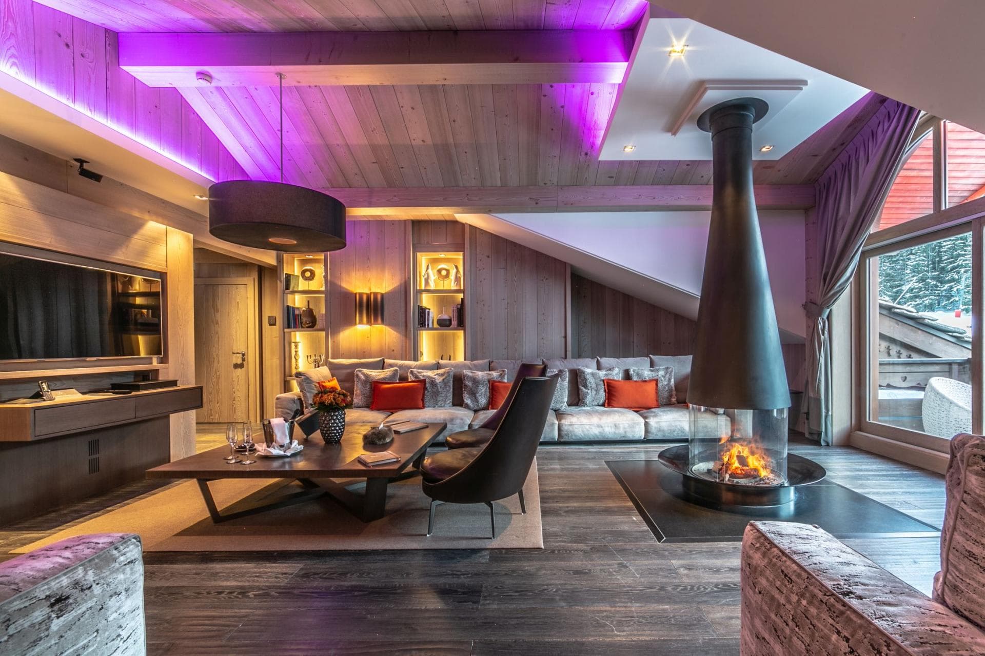 Living area with 360-degree glass fireplace and LED ambient lighting