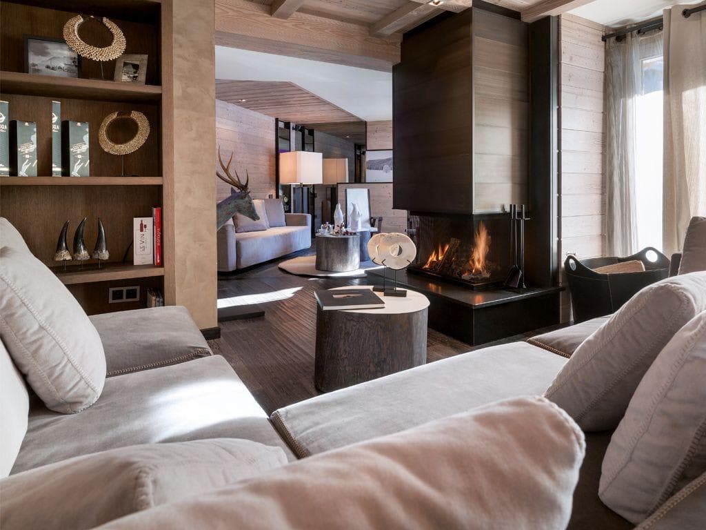 Living area with wood-burning fireplace and sectional sofa seating