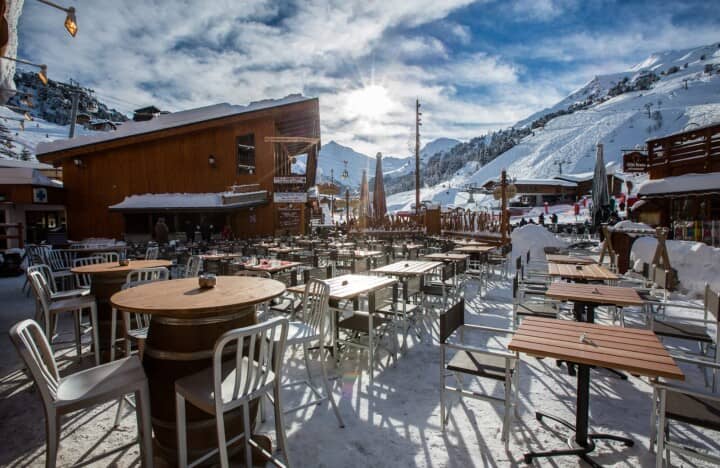 Ski-in dining terrace with sun-facing seating and mountain views