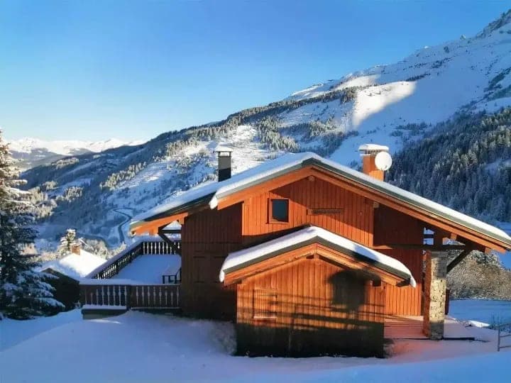 Ski-in, ski-out timber chalet with wrap-around balcony and valley views