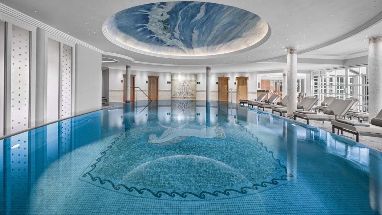 Indoor pool with horse mosaic tile and hand-painted ceiling mural