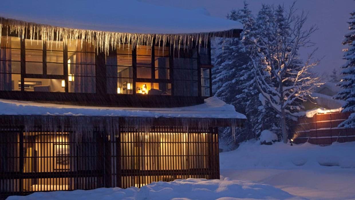 Two-story exterior with floor-to-ceiling windows and privacy screens