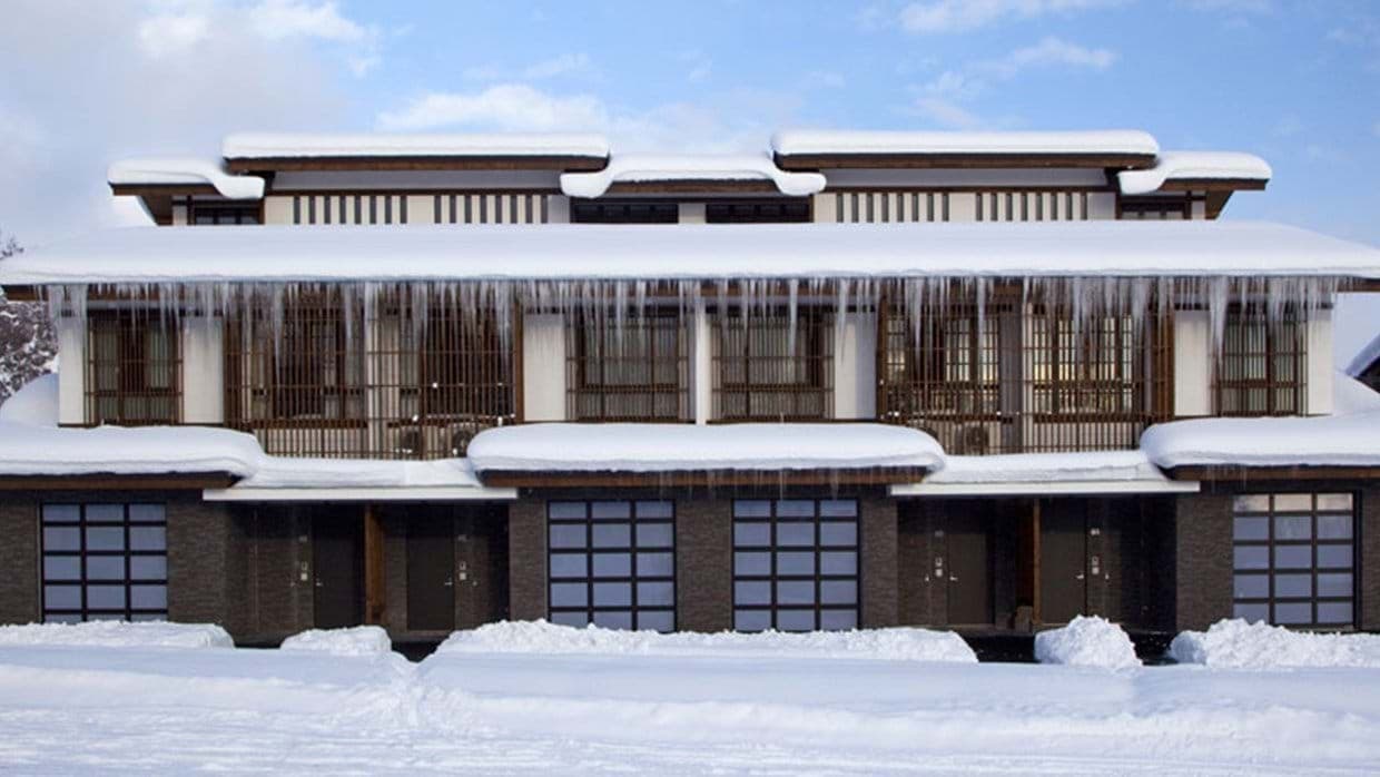 Ski chalet exterior with private heated garage and traditional lattice screening