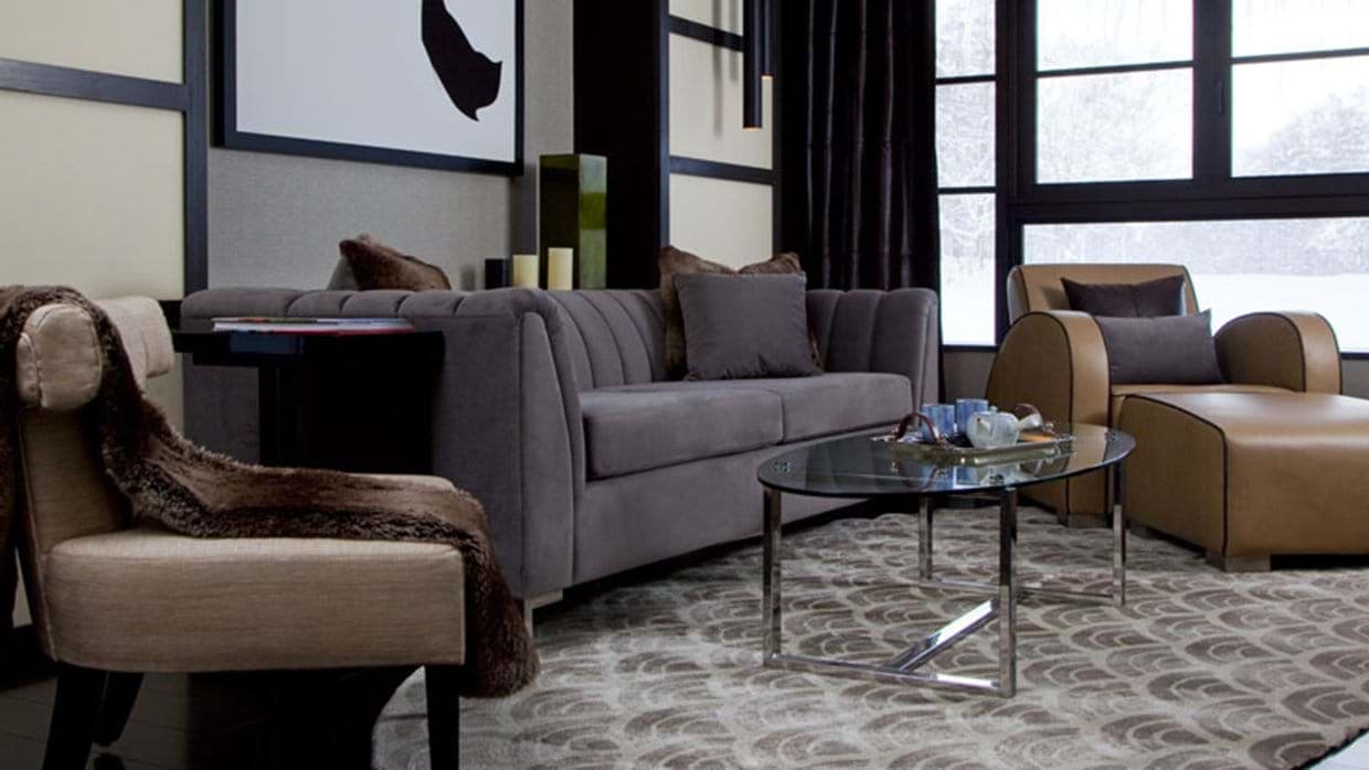 Living area with floor-to-ceiling windows and wooded winter views