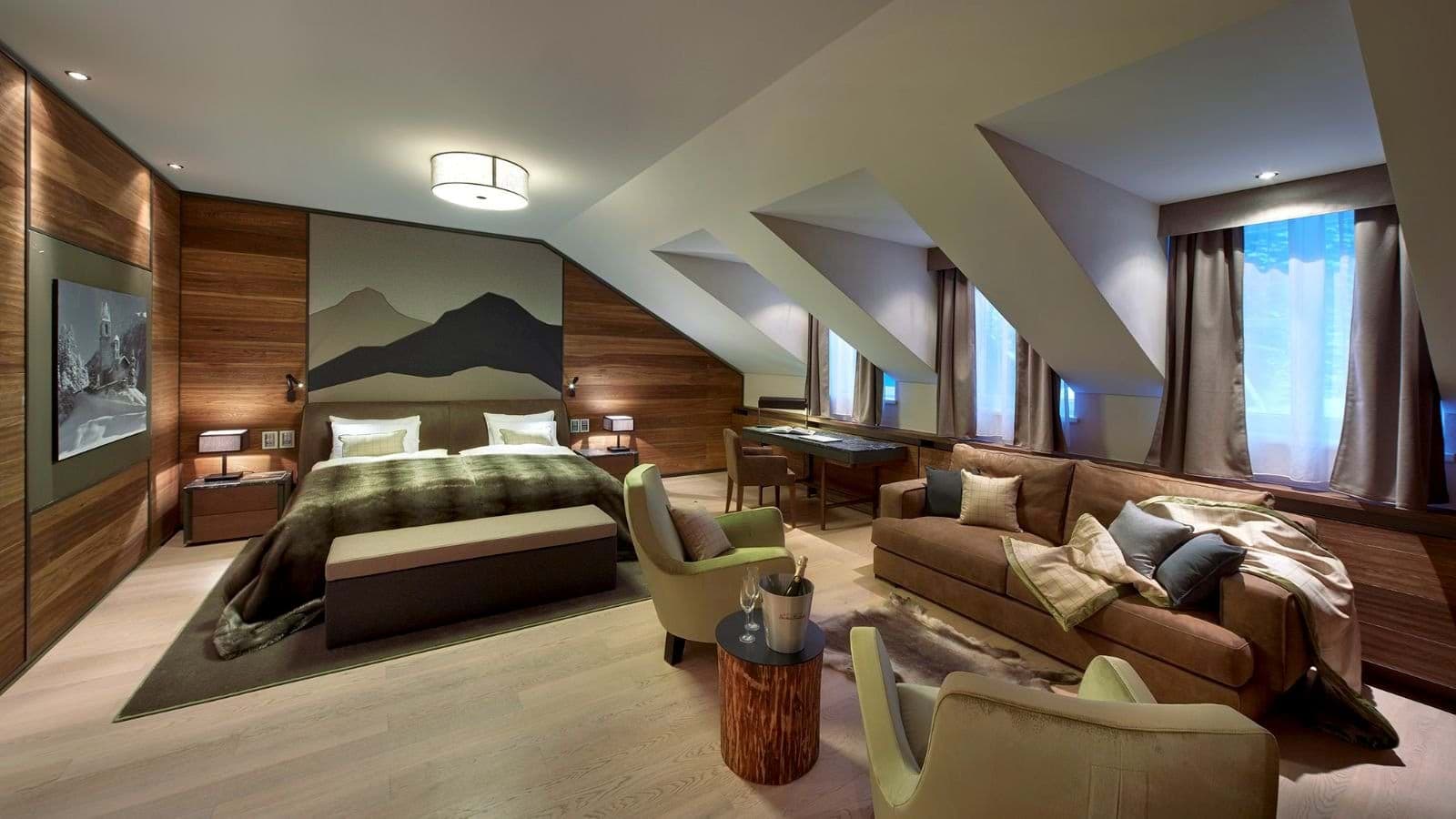 Primary suite with king bed, dedicated workspace, and separate lounge area