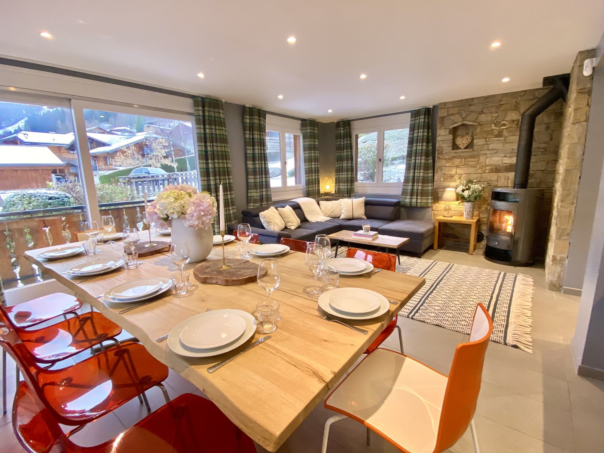Open-plan dining and living area; dining table seats 8, wood-burning stove, valley views