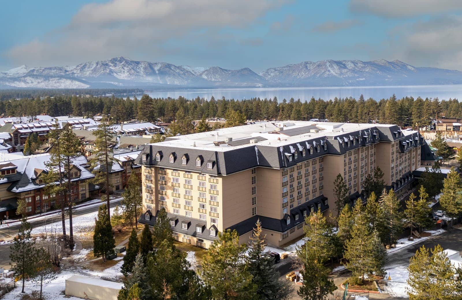Aerial view of resort exterior with Lake Tahoe and mountain backdrop