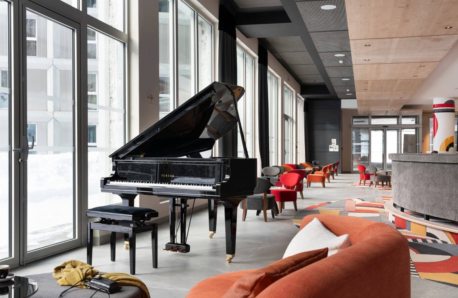 Lobby lounge with Yamaha grand piano and floor-to-ceiling windows