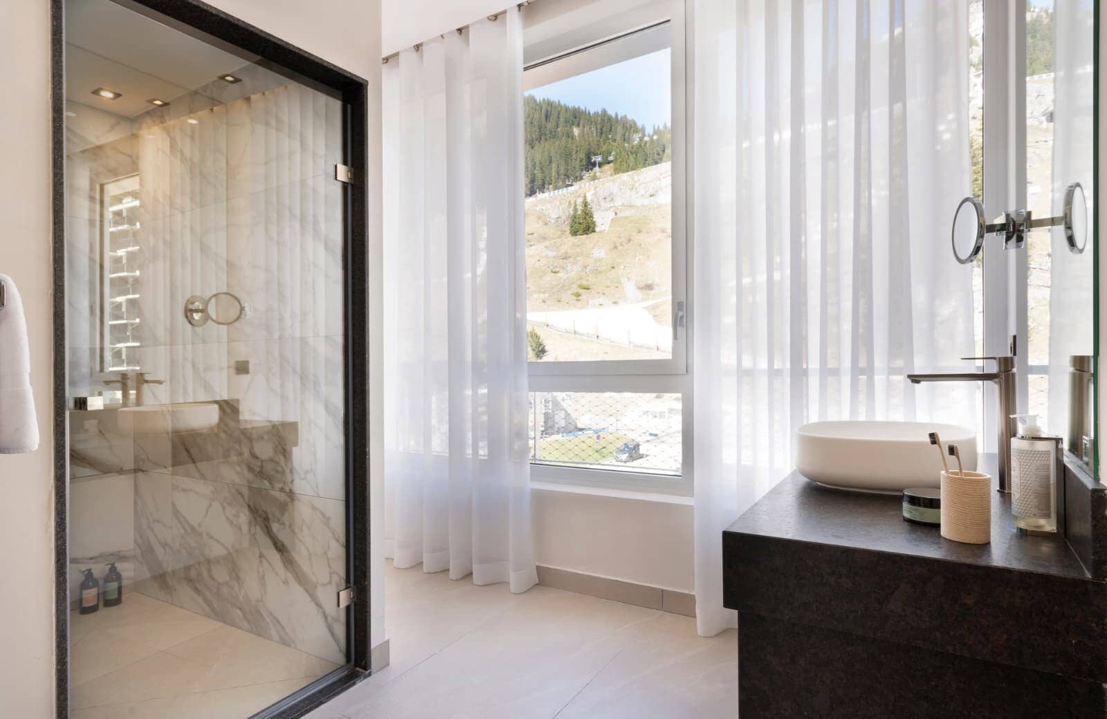 Bathroom with walk-in marble shower and mountain slope views
