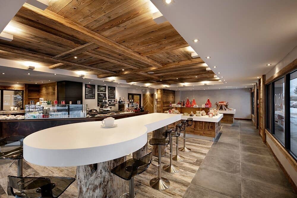 Coffee bar and deli with reclaimed wood ceilings and bar seating