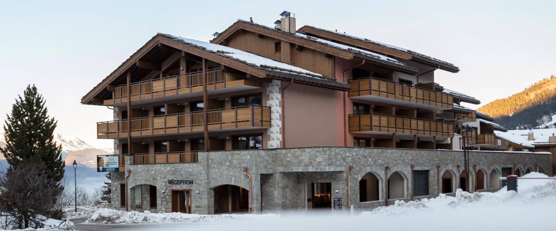 Ski-in chalet exterior featuring private balconies and ground-floor reception entrance