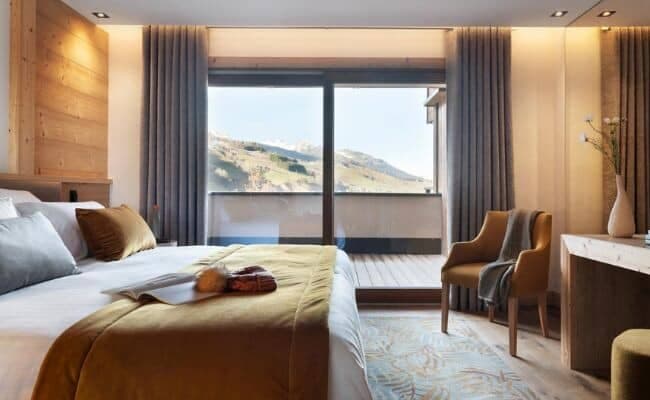 Primary bedroom with king bed and private mountain-view balcony