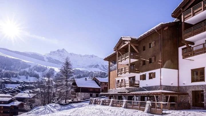 Ski-in ski-out chalet exterior with private balconies and mountain views
