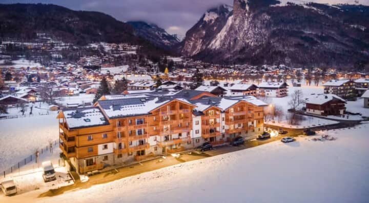 Chalet exterior at dusk with mountain views and onsite parking