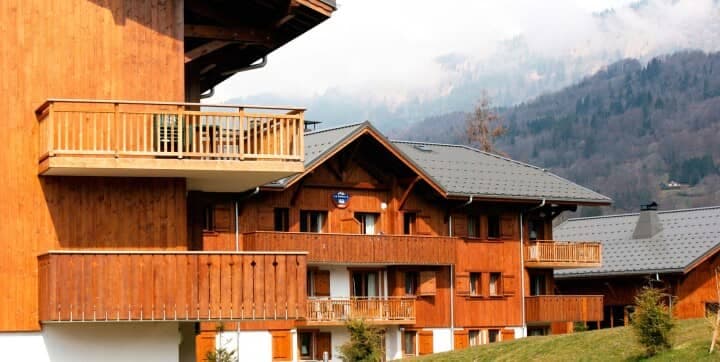 Timber chalet exterior with private balconies and mountain views
