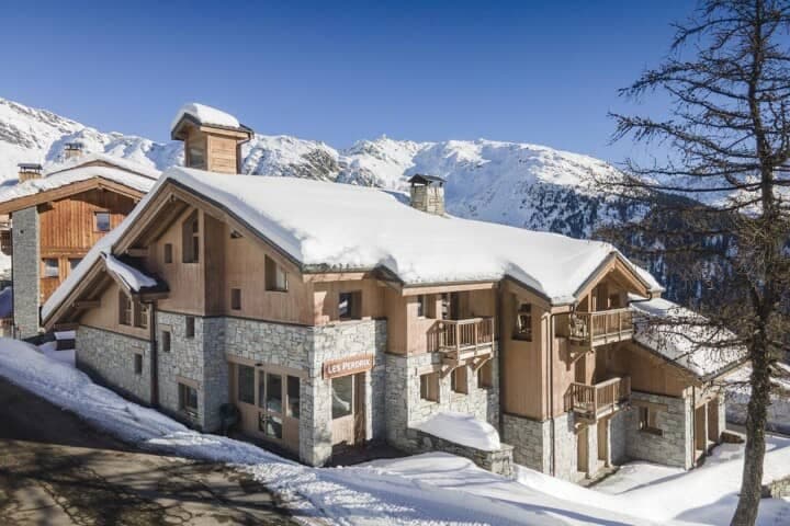 Ski-in chalet exterior with private balconies and mountain views