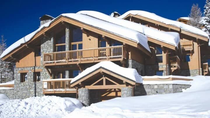 Ski-in exterior with private balconies and stone masonry
