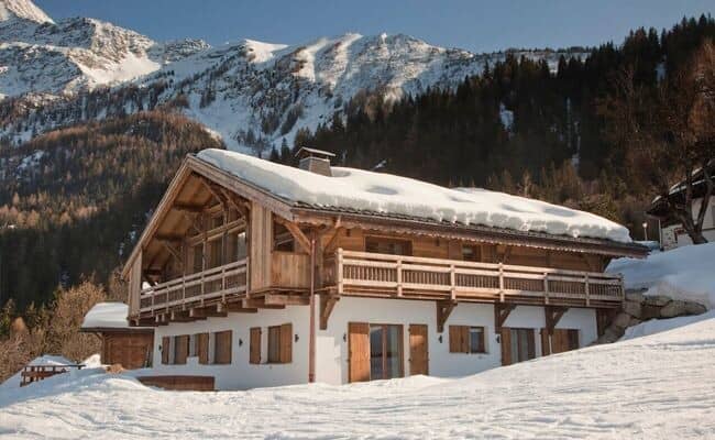 Mountain chalet with wrap-around balcony and timber shutters