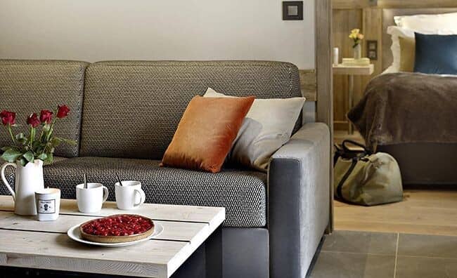 Living area adjacent to bedroom in open-concept studio suite