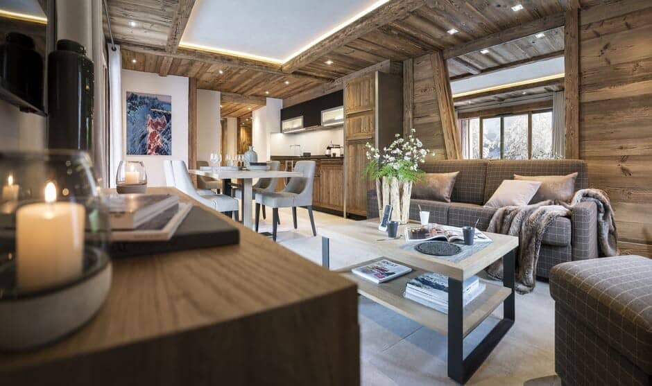 Open-plan living area with sofa bed and four-person dining table