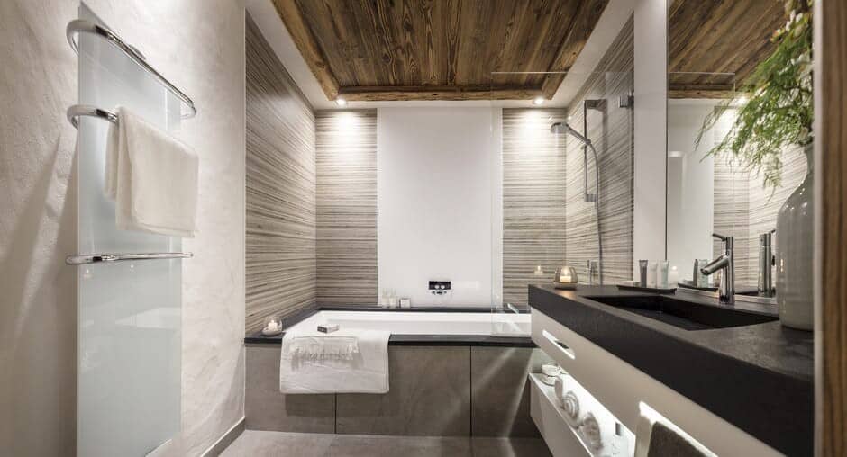 Bathroom with soaking tub, walk-in shower, and heated towel rack