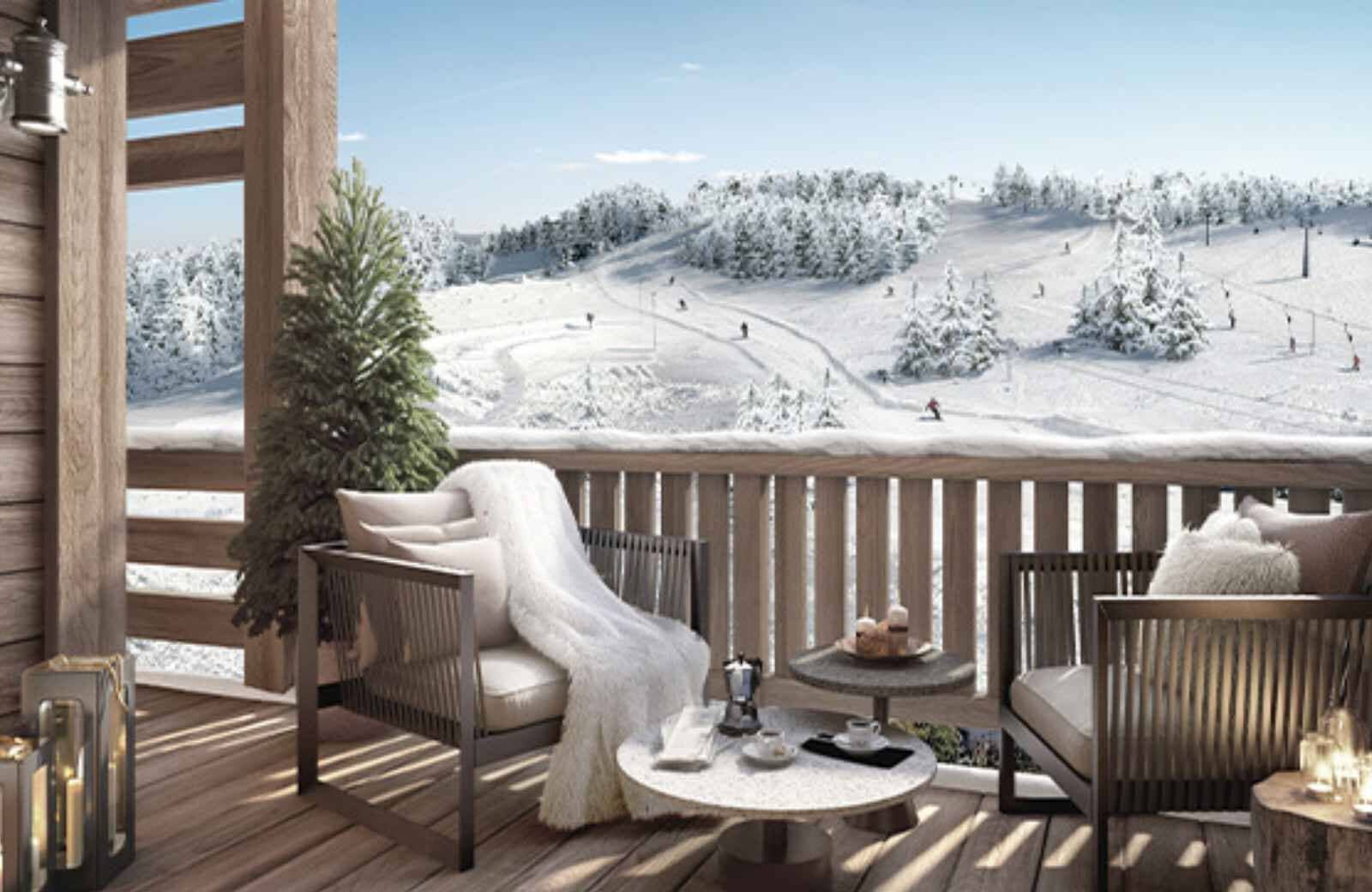 Private balcony with lounge seating and direct ski-in/ski-out slope views