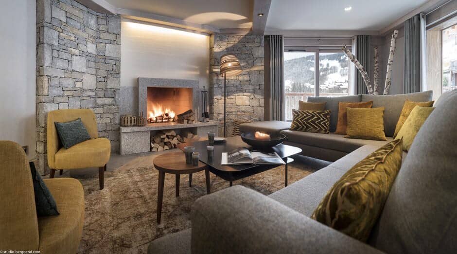 Living area with wood-burning fireplace and mountain valley views