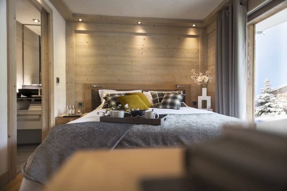 Primary bedroom with ensuite access and snow-covered terrace views